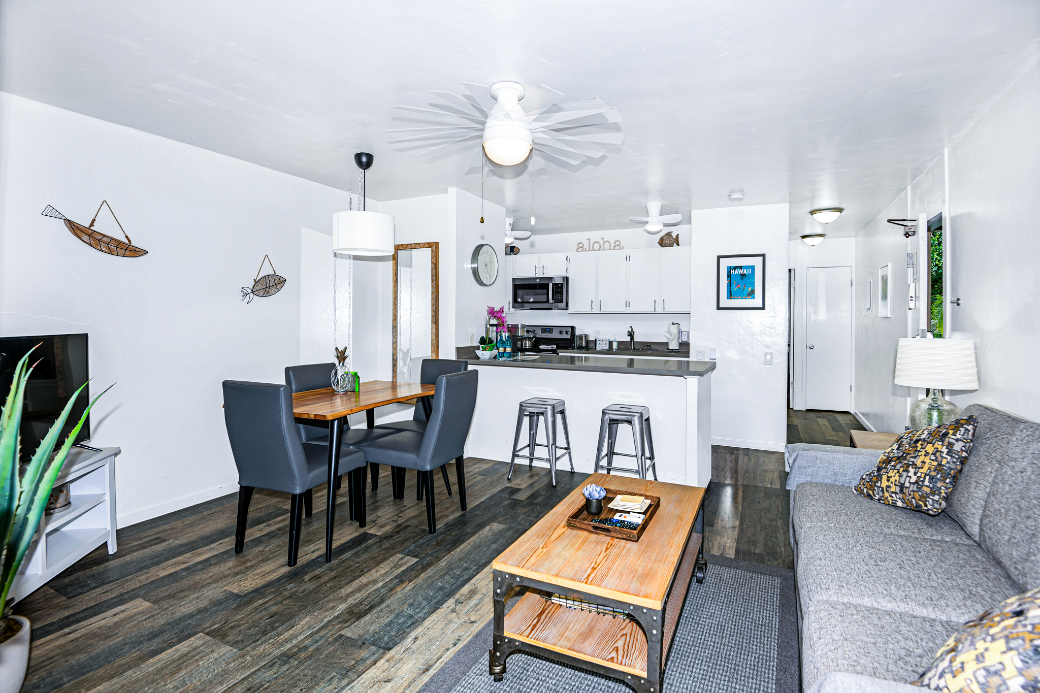 a living room with kitchen island furniture and a chandelier