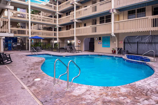 a view of a swimming pool with sitting area