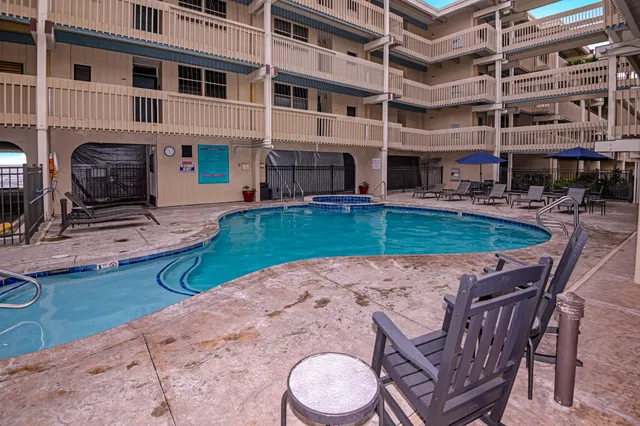 a view of a swimming pool with a table and chairs