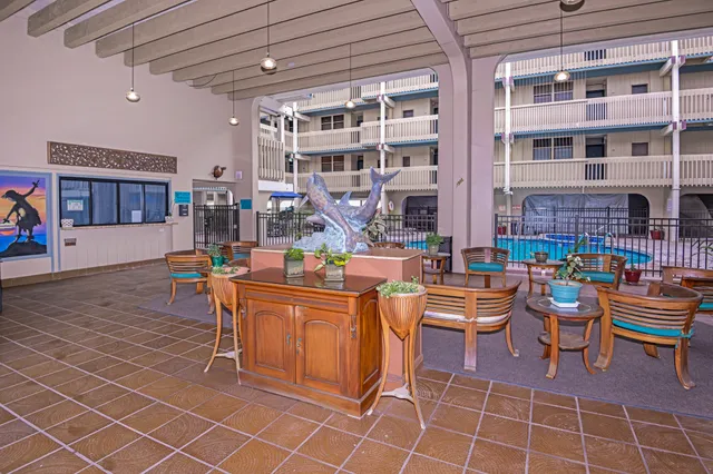 a living room with furniture a dining table and chairs
