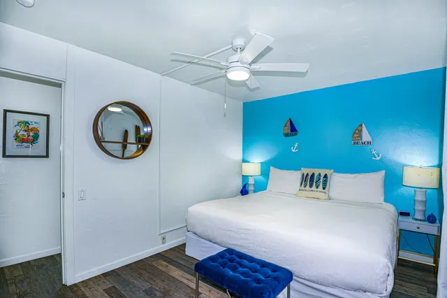 a bedroom with a bed and a mirror