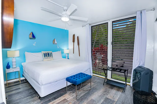 a bedroom with furniture and a large window