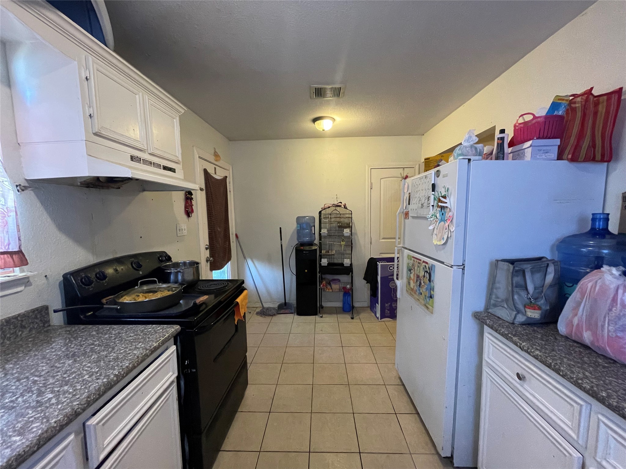 7928 Buchanan Street Houston, TX 77029 - Photo 11 of 25 a kitchen with stainless steel appliances granite countertop a stove and a refrigerator