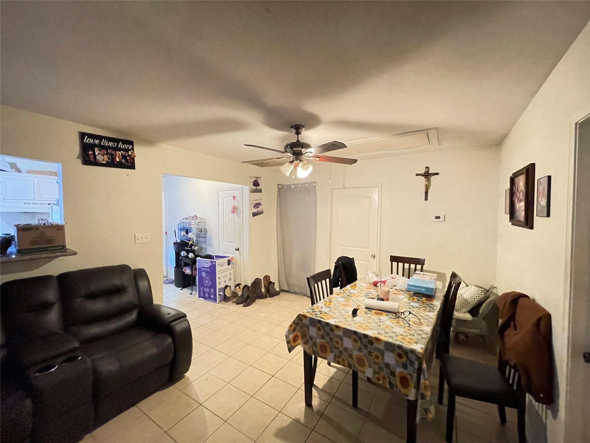 7928 Buchanan Street Houston, TX 77029 - Photo 14 of 25 a living room with furniture a chandelier and a flat screen tv