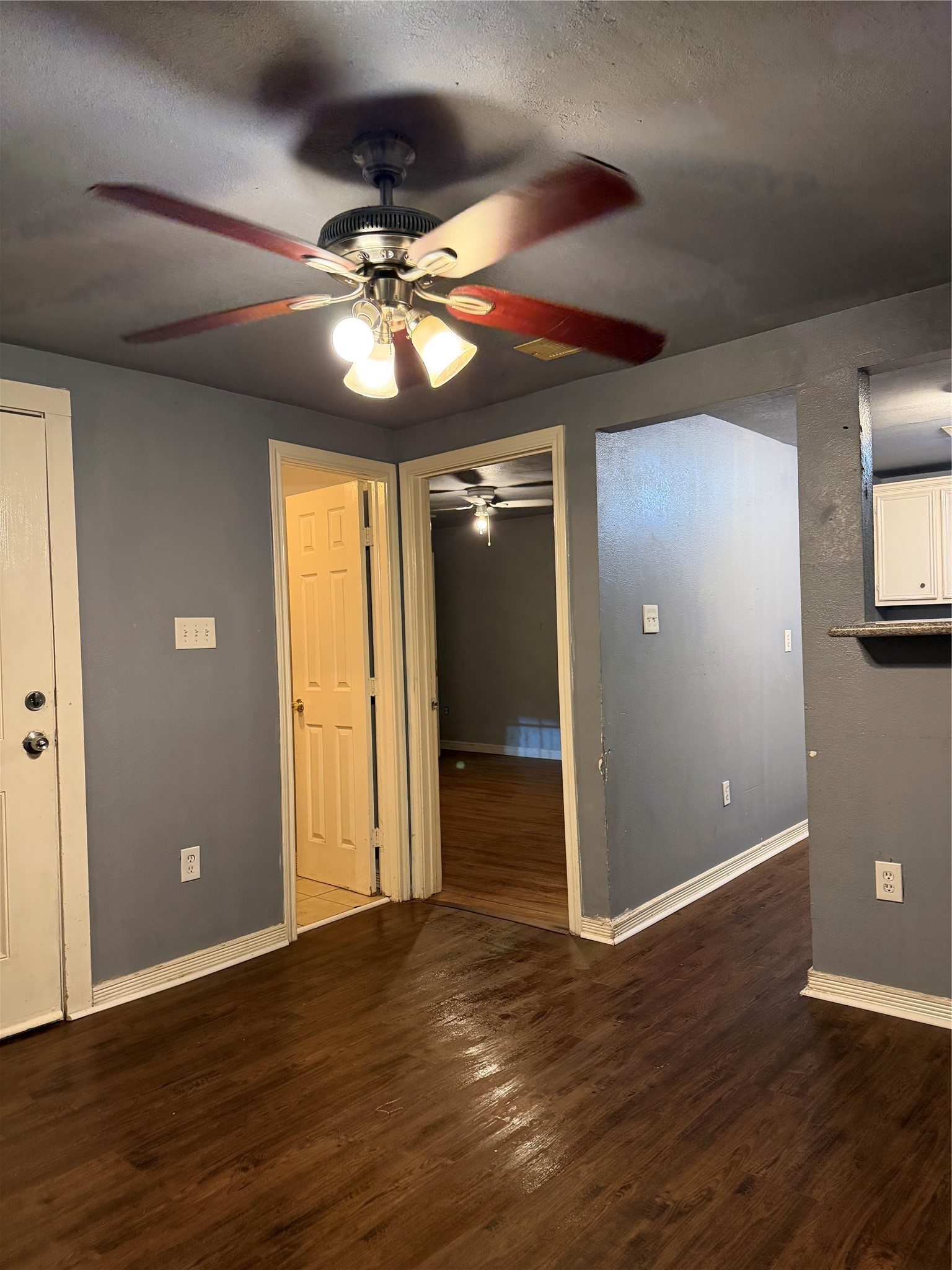 7928 Buchanan Street Houston, TX 77029 - Photo 20 of 25 a view of an empty room with wooden floor and a ceiling fan