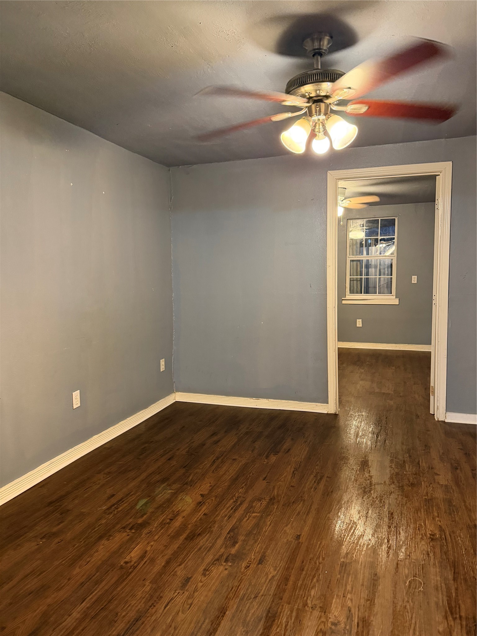 7928 Buchanan Street Houston, TX 77029 - Photo 23 of 25 a view of an empty room with wooden floor and a chandelier