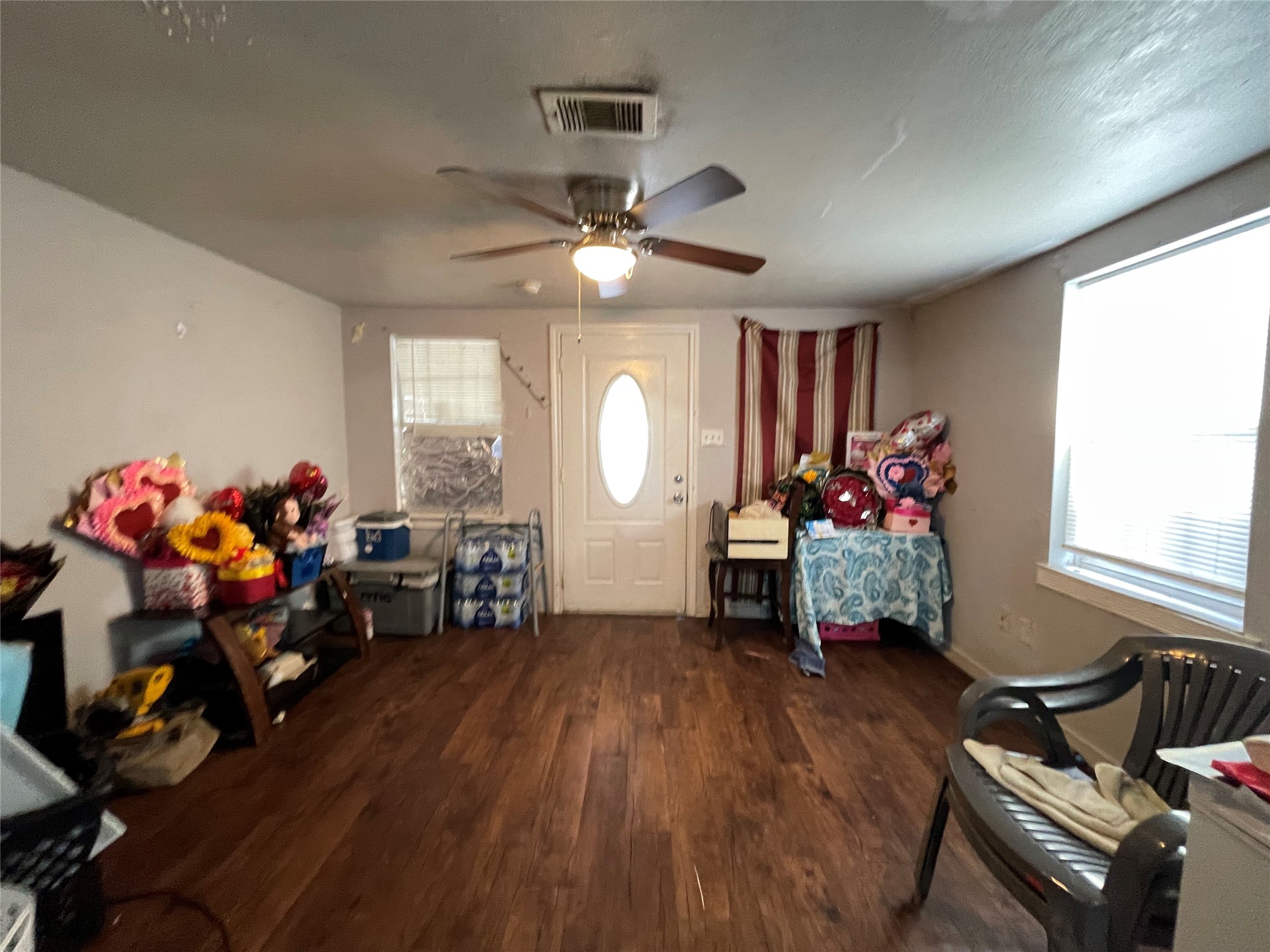 7928 Buchanan Street Houston, TX 77029 - Photo 4 of 25 a living room filled with furniture and a chandelier