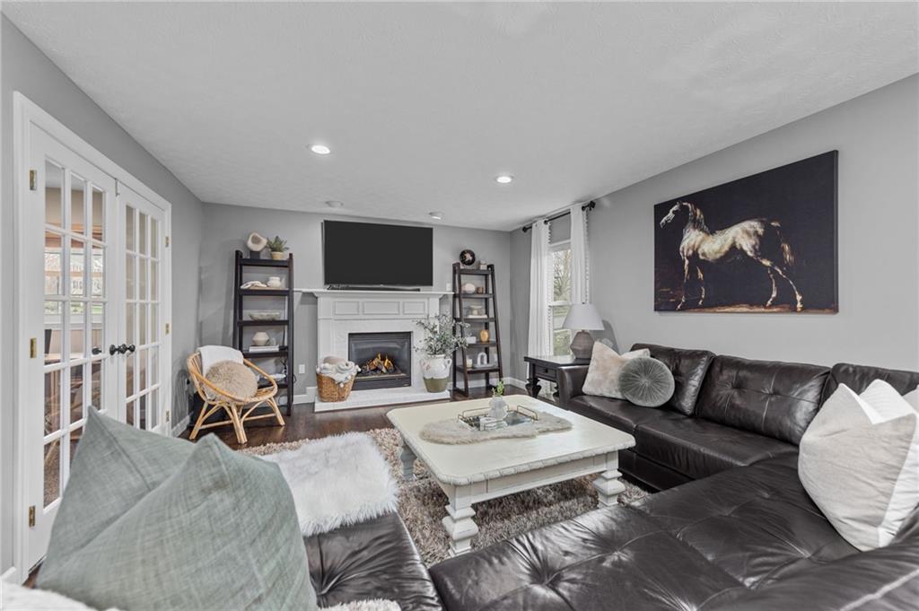 254 Cliffside Drive Mars, PA 16046 - Photo 12 of 25 a living room with furniture a fireplace and a flat screen tv