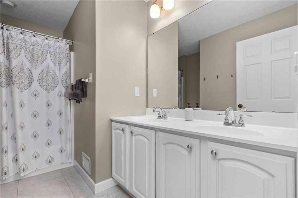 254 Cliffside Drive Mars, PA 16046 - Photo 21 of 25 a bathroom with a double vanity sink and mirror