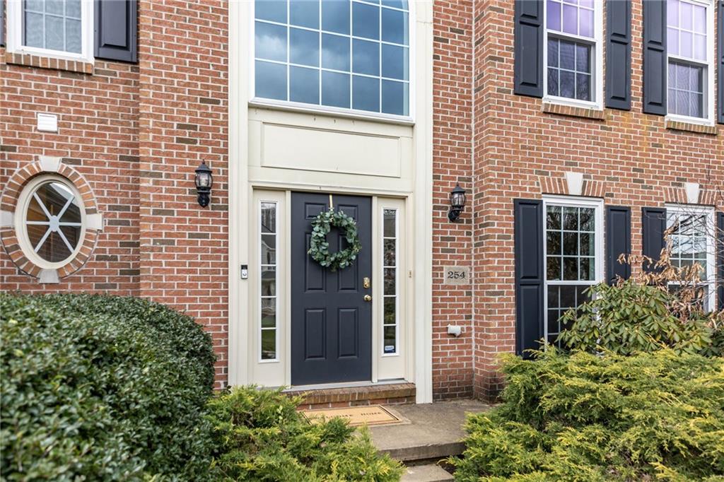 254 Cliffside Drive Mars, PA 16046 - Photo 4 of 25 a view of a brick house with large windows and potted plants