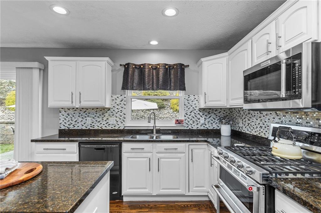 254 Cliffside Drive Mars, PA 16046 - Photo 9 of 25 a kitchen with stainless steel appliances granite countertop a sink stove and cabinets