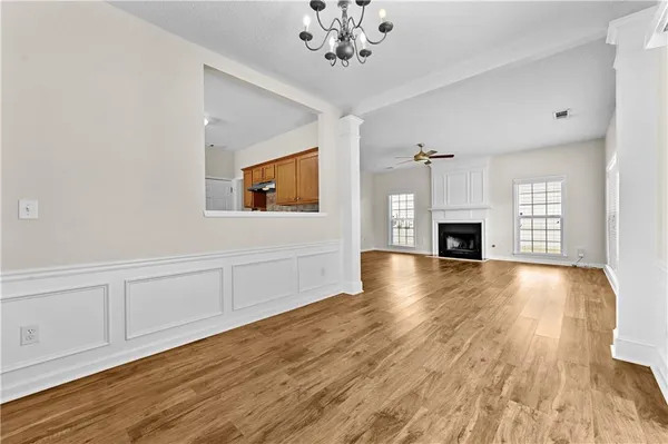 a view of empty room with wooden floor fireplace and windows