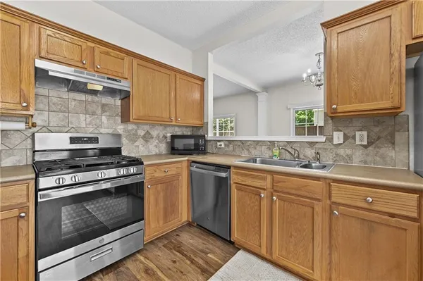 a kitchen with cabinets appliances and a sink