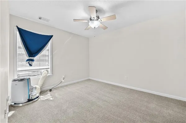 a view of room with ceiling fan