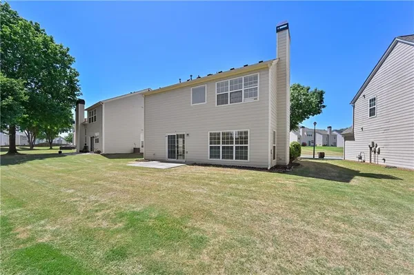 a view of a house with a backyard