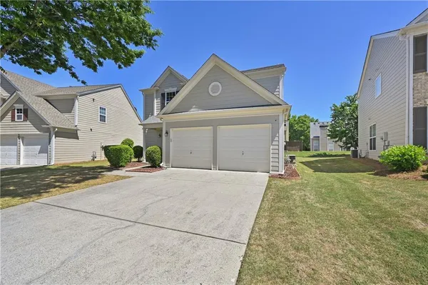 a front view of a house with a yard and garage