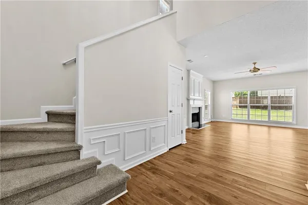 a view of an entryway with wooden floor and windows