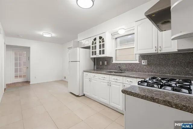a kitchen with a sink a stove and cabinets