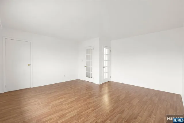 a view of an empty room and wooden floor