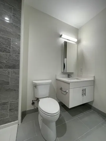 an empty room with wooden floor and window