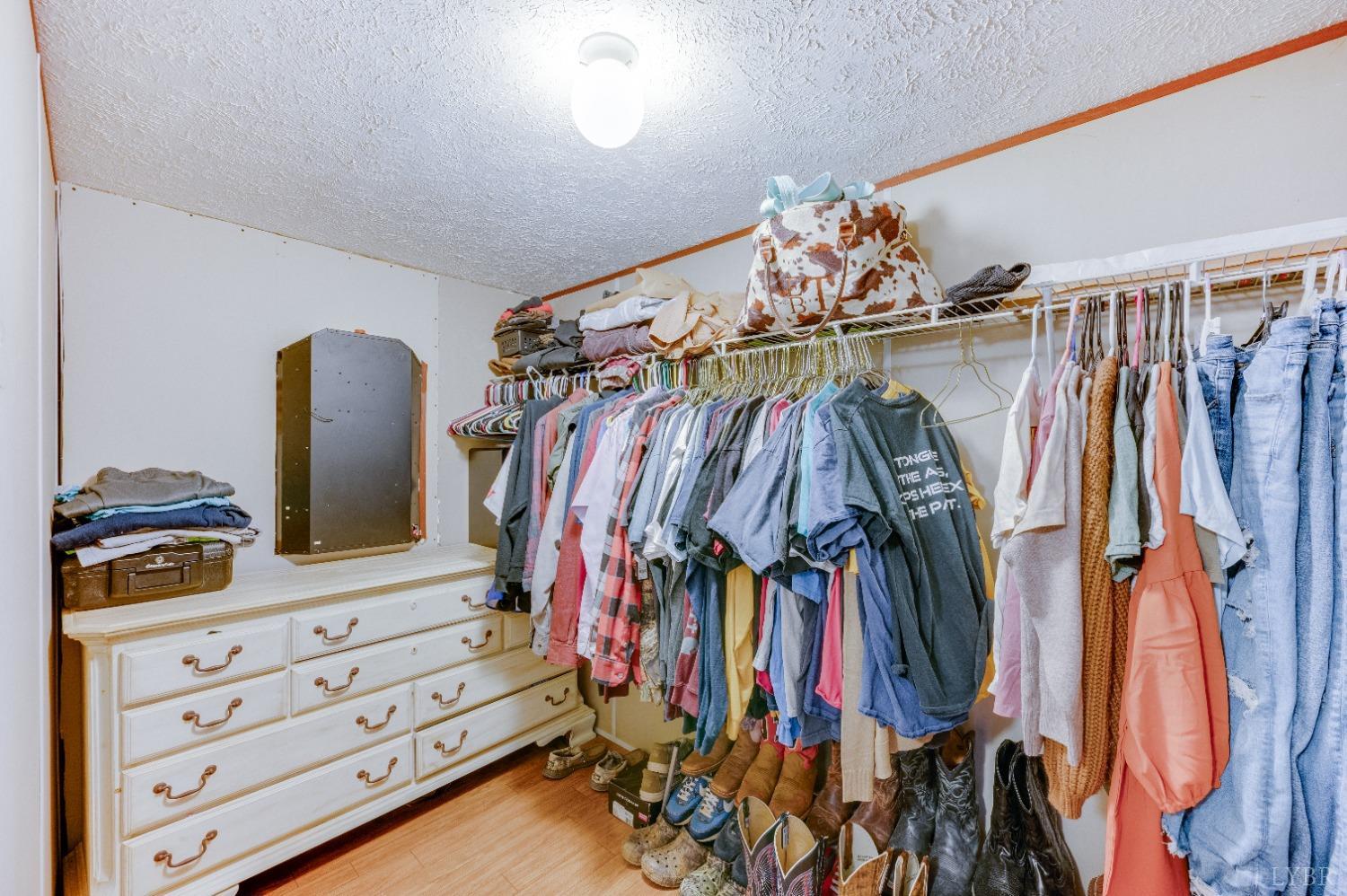 276 Beeks Lane Spout Spring, VA 24593 - Photo 13 of 29 a view of walk in closet with clothes