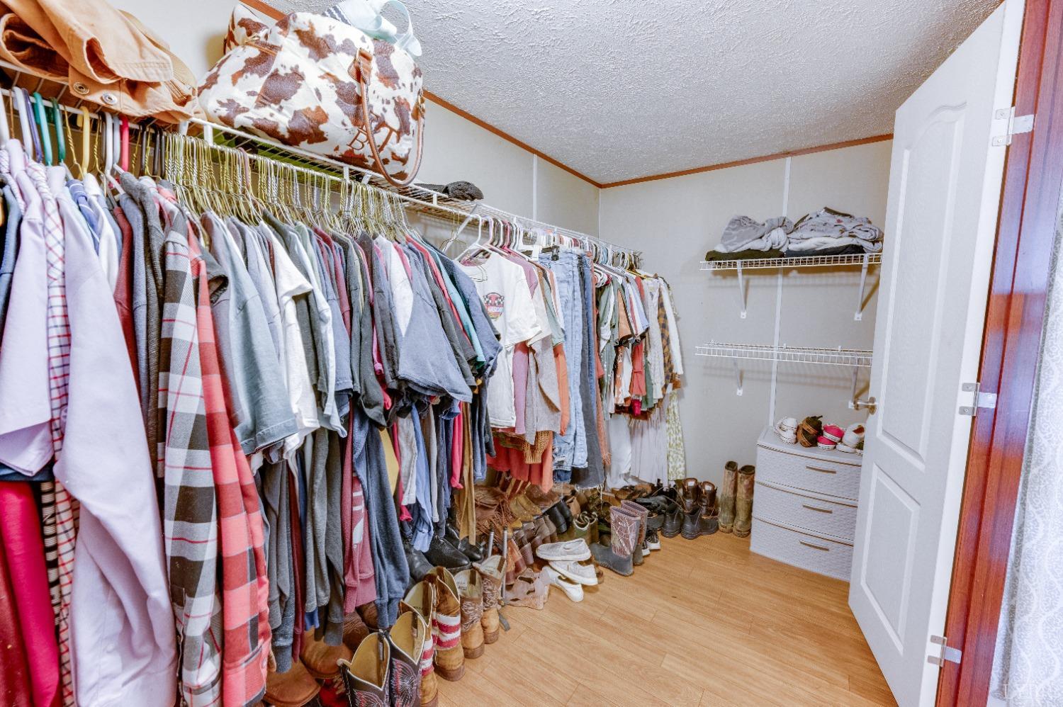 276 Beeks Lane Spout Spring, VA 24593 - Photo 14 of 29 a view of walk in closet with clothes and shoes