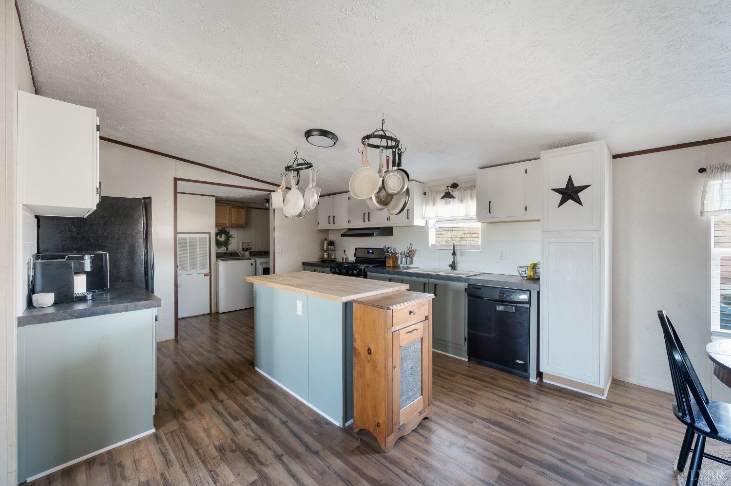 276 Beeks Lane Spout Spring, VA 24593 - Photo 6 of 29 a kitchen with stainless steel appliances granite countertop a refrigerator a sink dishwasher a stove and white countertops with wooden floor