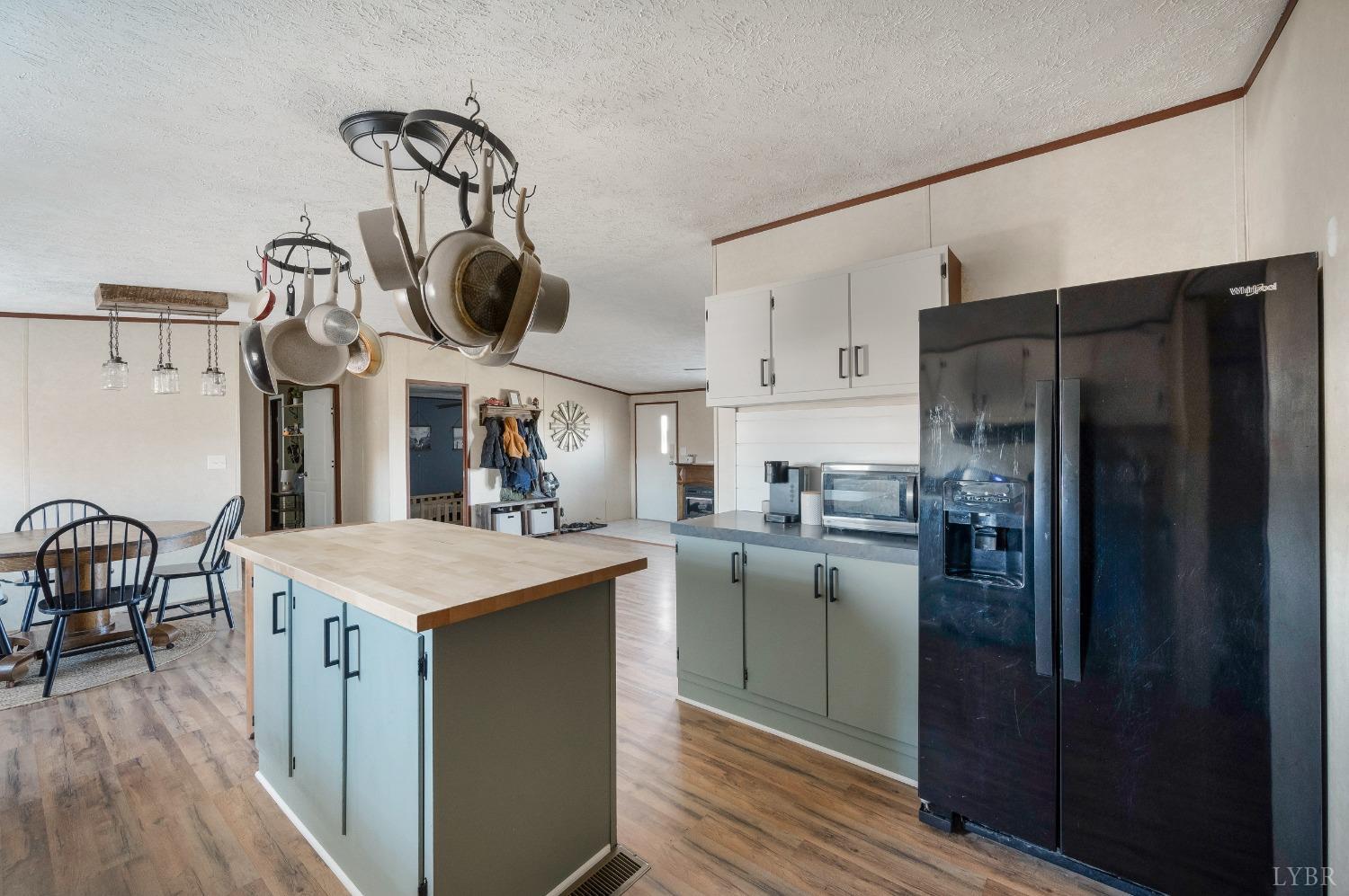 276 Beeks Lane Spout Spring, VA 24593 - Photo 7 of 29 a kitchen with a refrigerator a sink and dishwasher with wooden floor