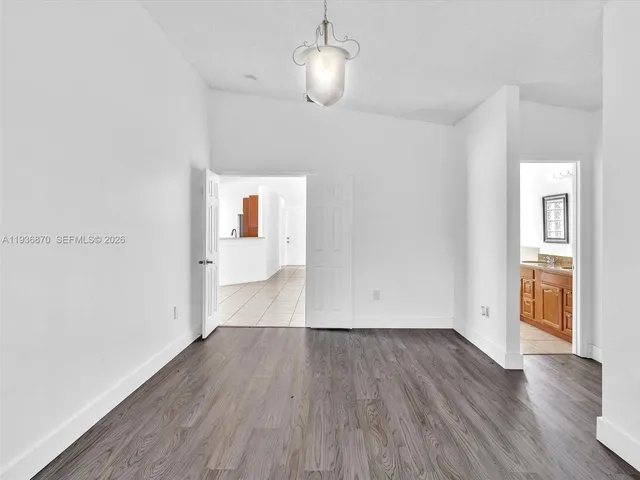 a bathroom with a granite countertop tub sink and mirror