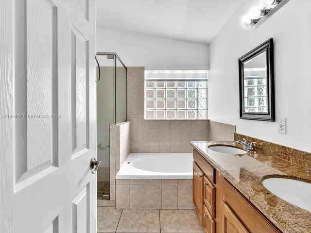 a bathroom with a bathtub and shower
