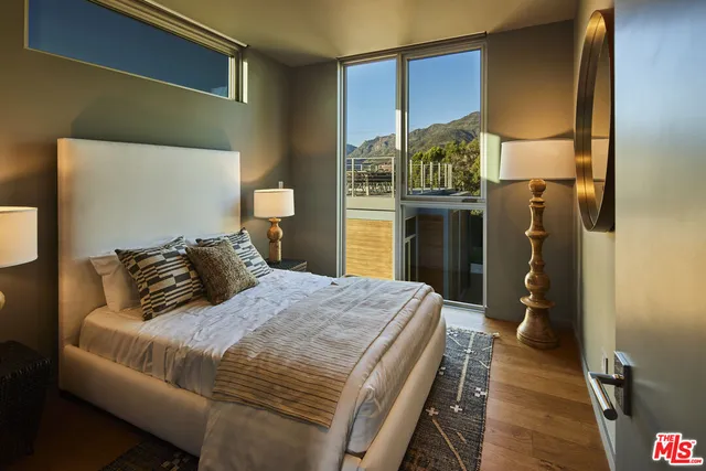 a view of roof deck with couches and city view