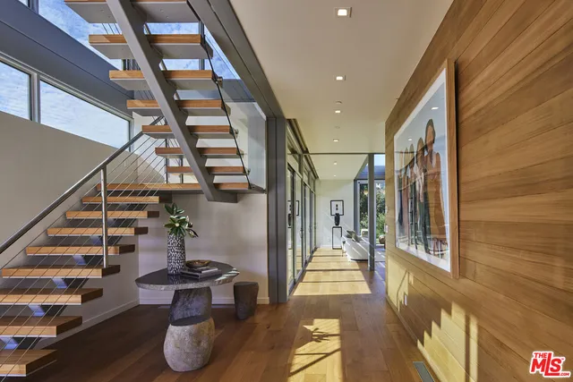 a living room with furniture and a floor to ceiling window