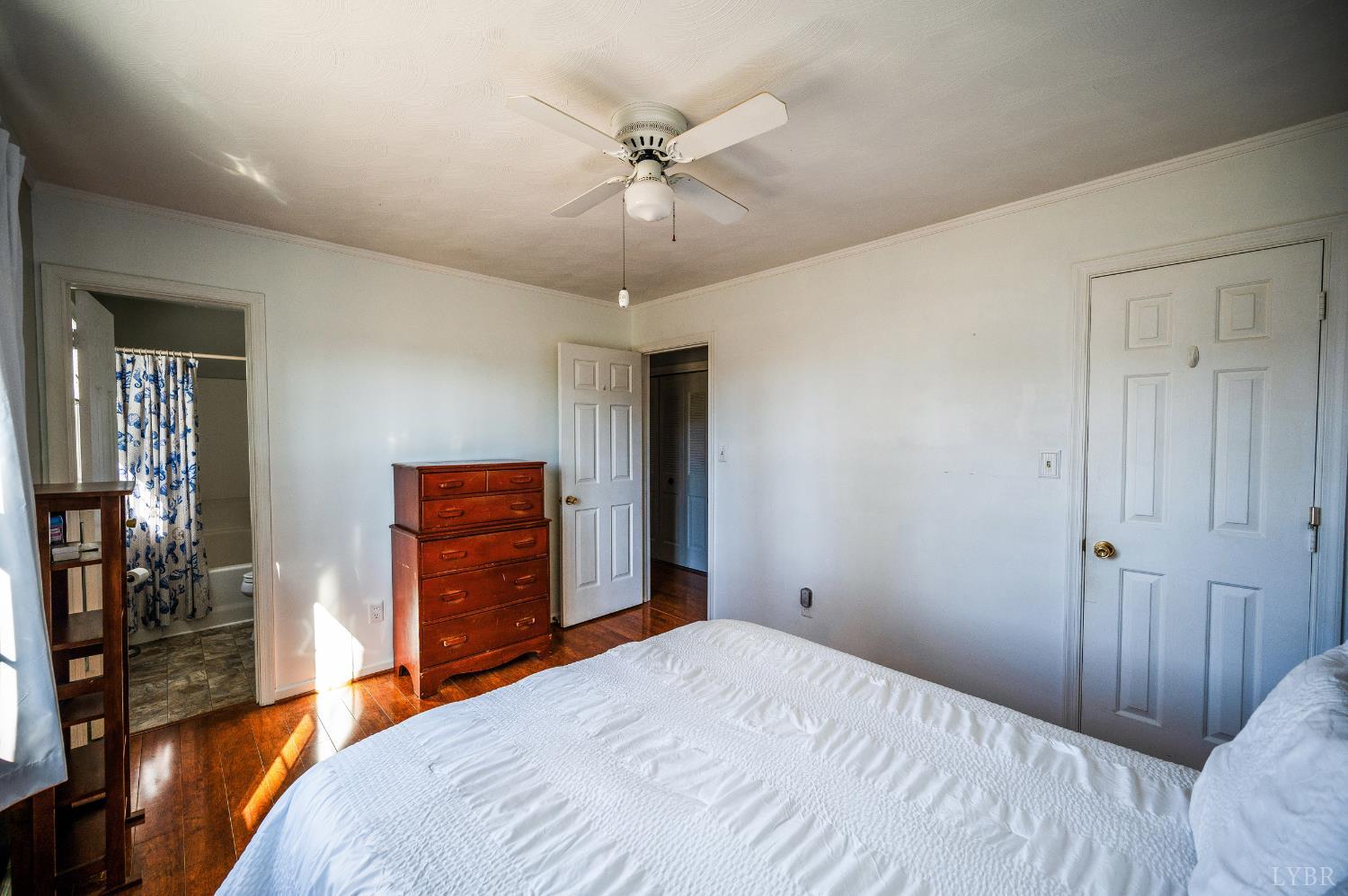2550 Town Fork Road Evington, VA 24550 - Photo 12 of 42 a bedroom with a bed and a chandelier