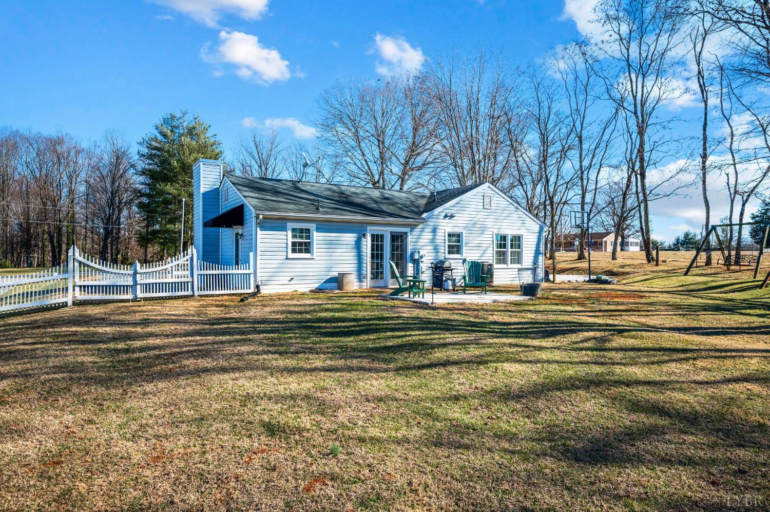 2550 Town Fork Road Evington, VA 24550 - Photo 20 of 42 a front view of a house with a yard table and chairs