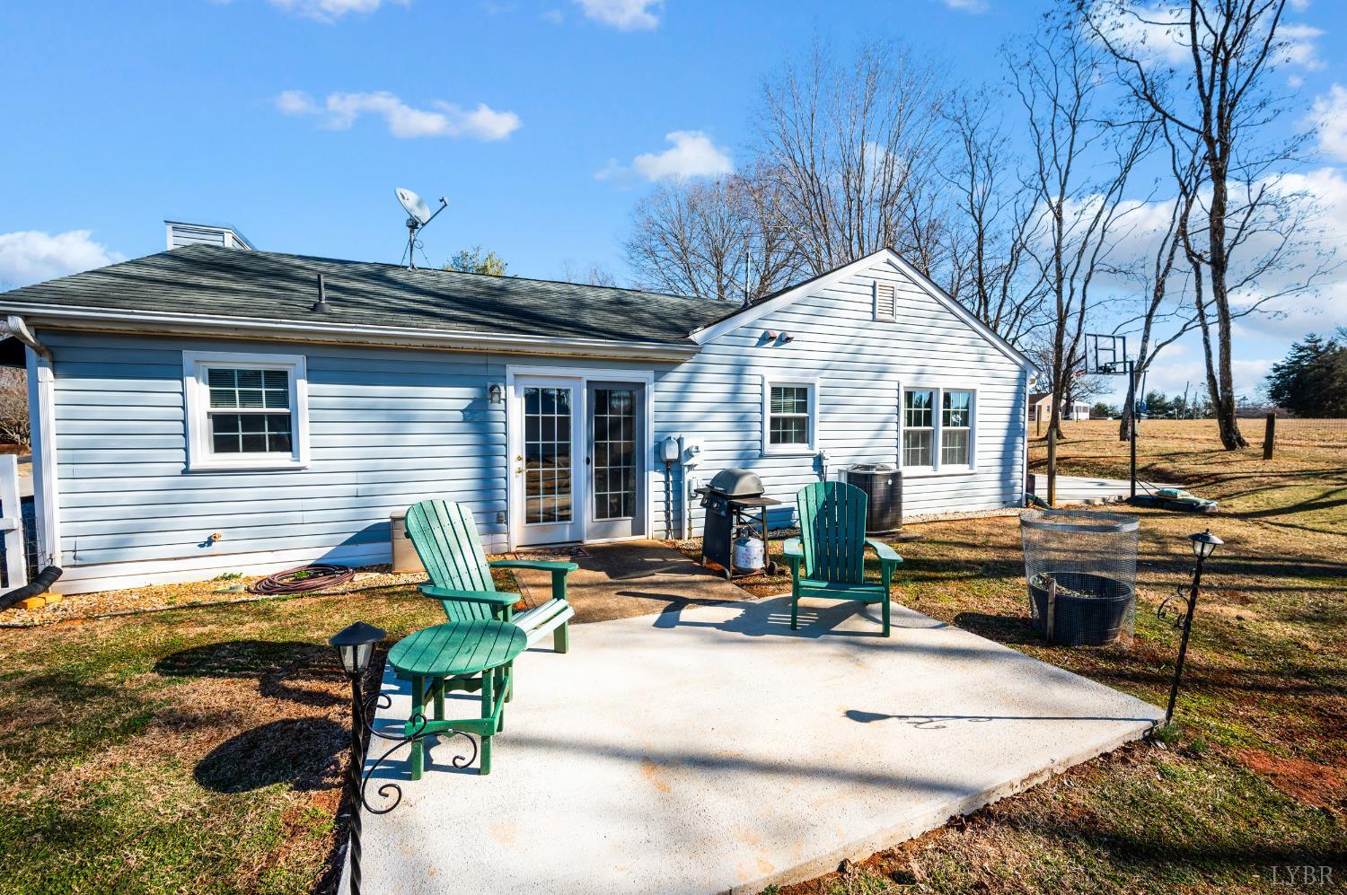 2550 Town Fork Road Evington, VA 24550 - Photo 22 of 42 a view of a patio with table and chairs and wooden fence
