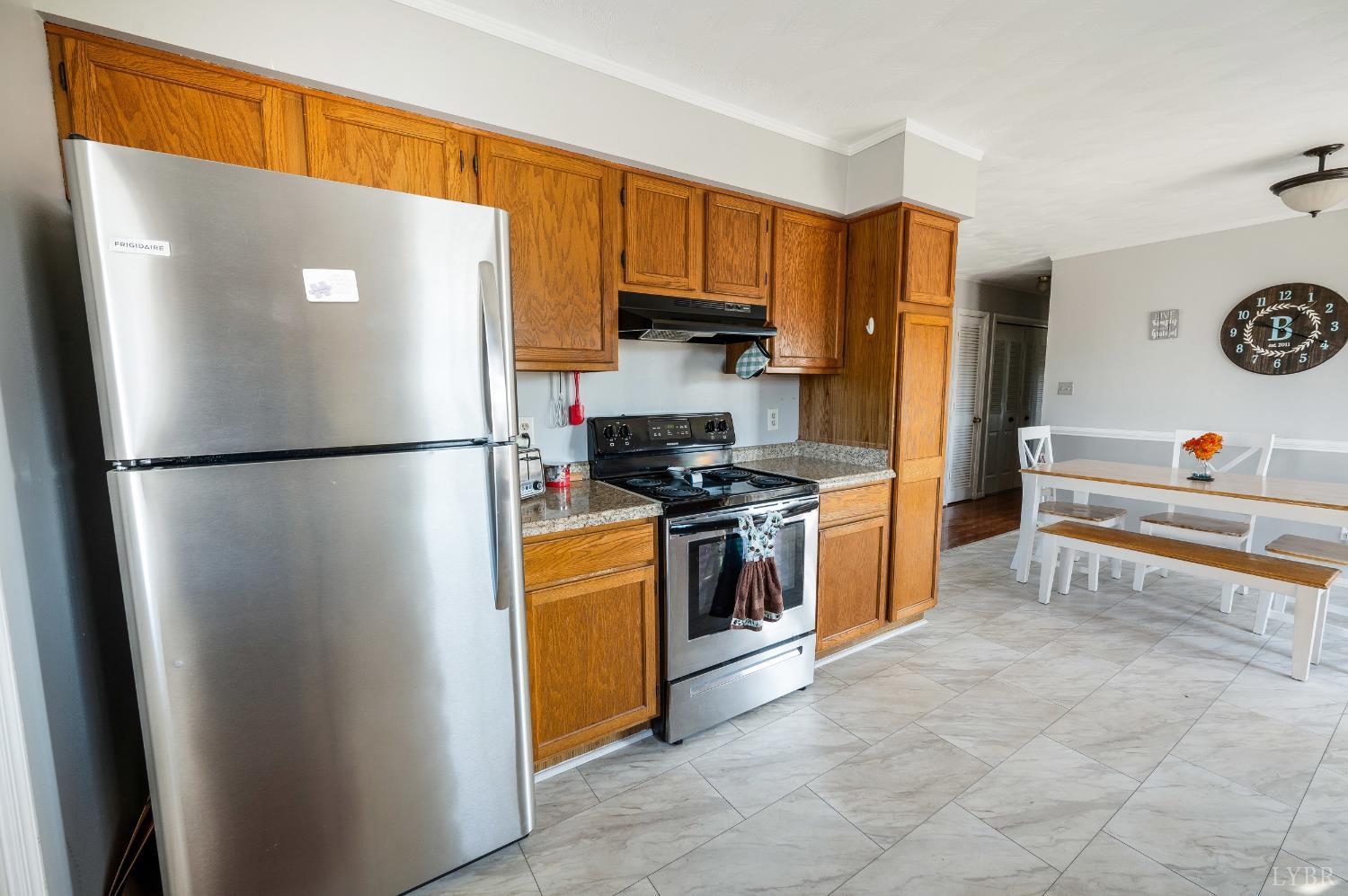 2550 Town Fork Road Evington, VA 24550 - Photo 8 of 42 a refrigerator freezer sitting in a kitchen with stainless steel appliances granite countertop a refrigerator and a stove top oven