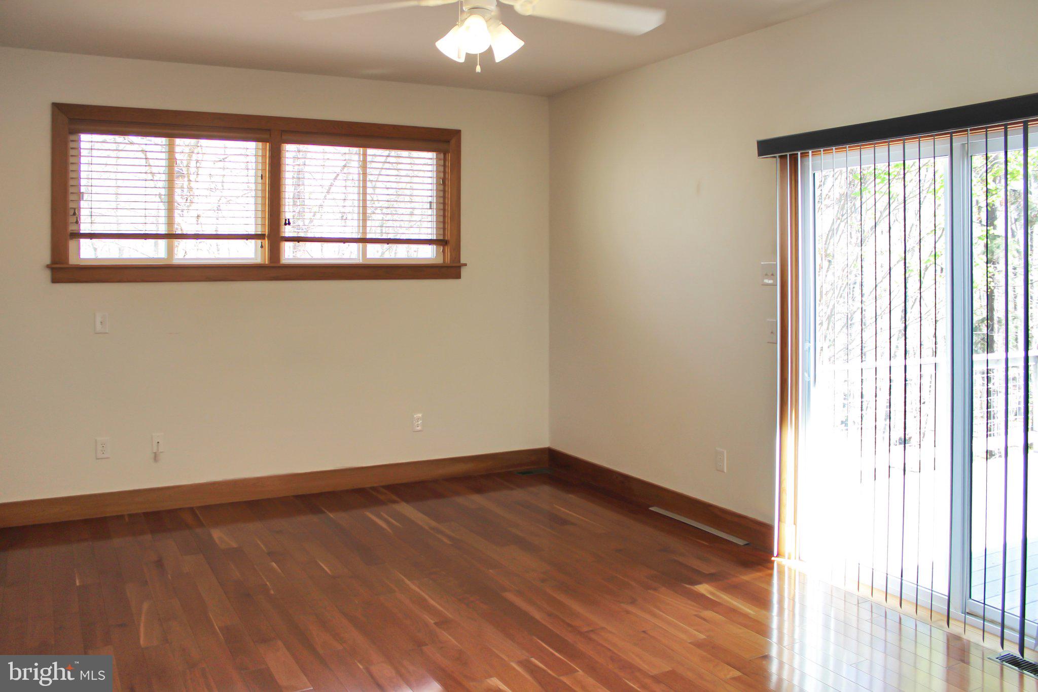 522 Unity Place Buckingham, VA 23921 - Photo 13 of 21 an empty room with wooden floor and windows