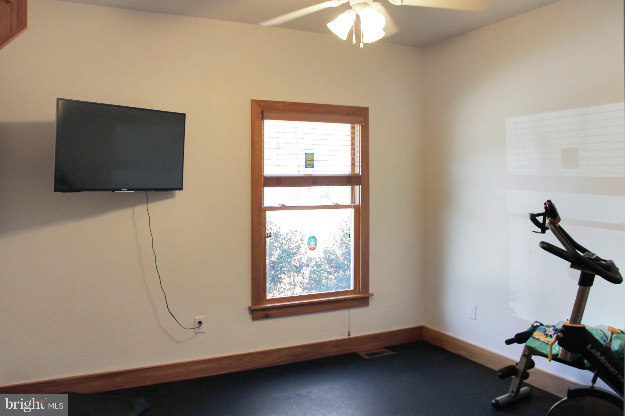 522 Unity Place Buckingham, VA 23921 - Photo 15 of 21 a room with gym equipment and a flat screen tv