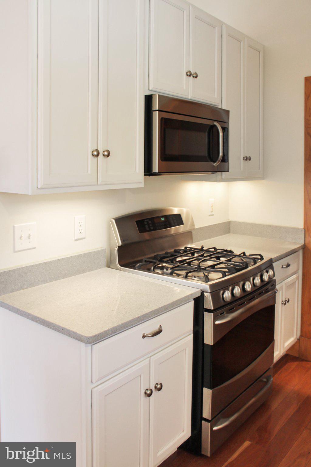 522 Unity Place Buckingham, VA 23921 - Photo 9 of 21 a kitchen with granite countertop white cabinets and stainless steel appliances