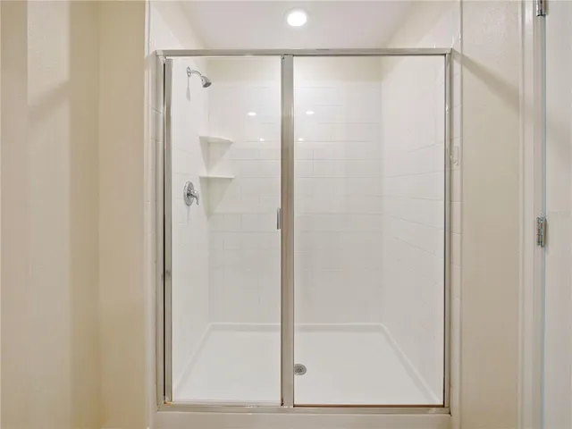 a bathroom with a glass shower door