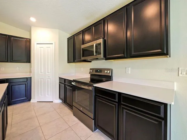 a kitchen with granite countertop stainless steel appliances and cabinets