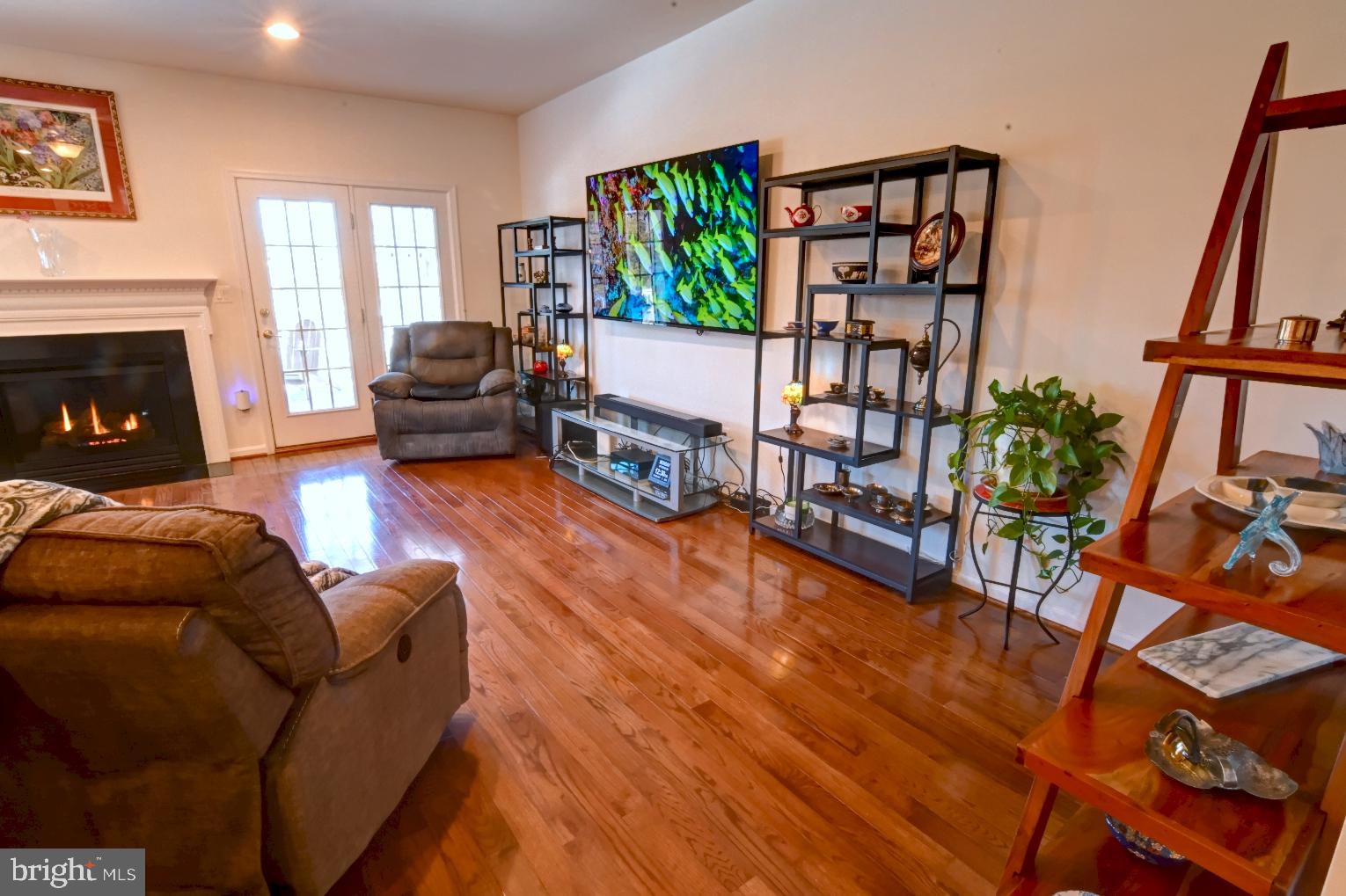 13170 Triple Crown Loop Gainesville, VA 20155 - Photo 28 of 71 a living room with furniture and a wooden floor