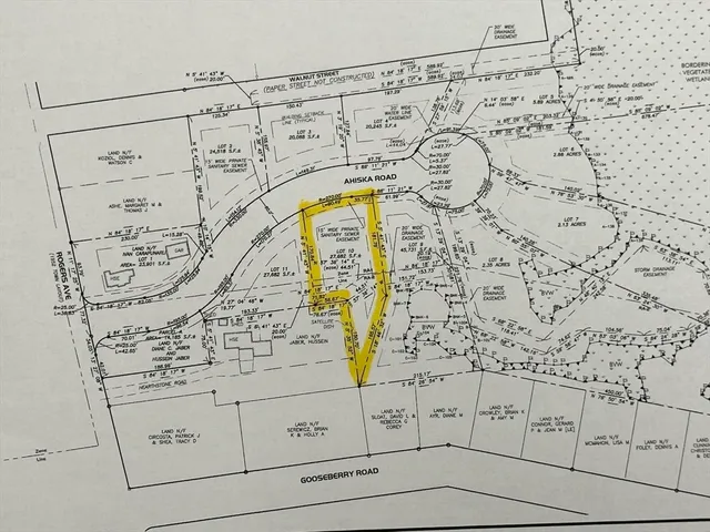 a small yard with lots of green space and plants in the back