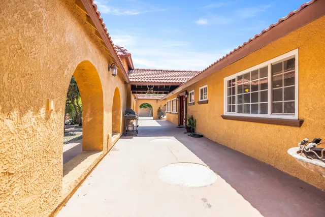 a kitchen with kitchen island granite countertop a stove top oven a sink a counter top space and cabinets