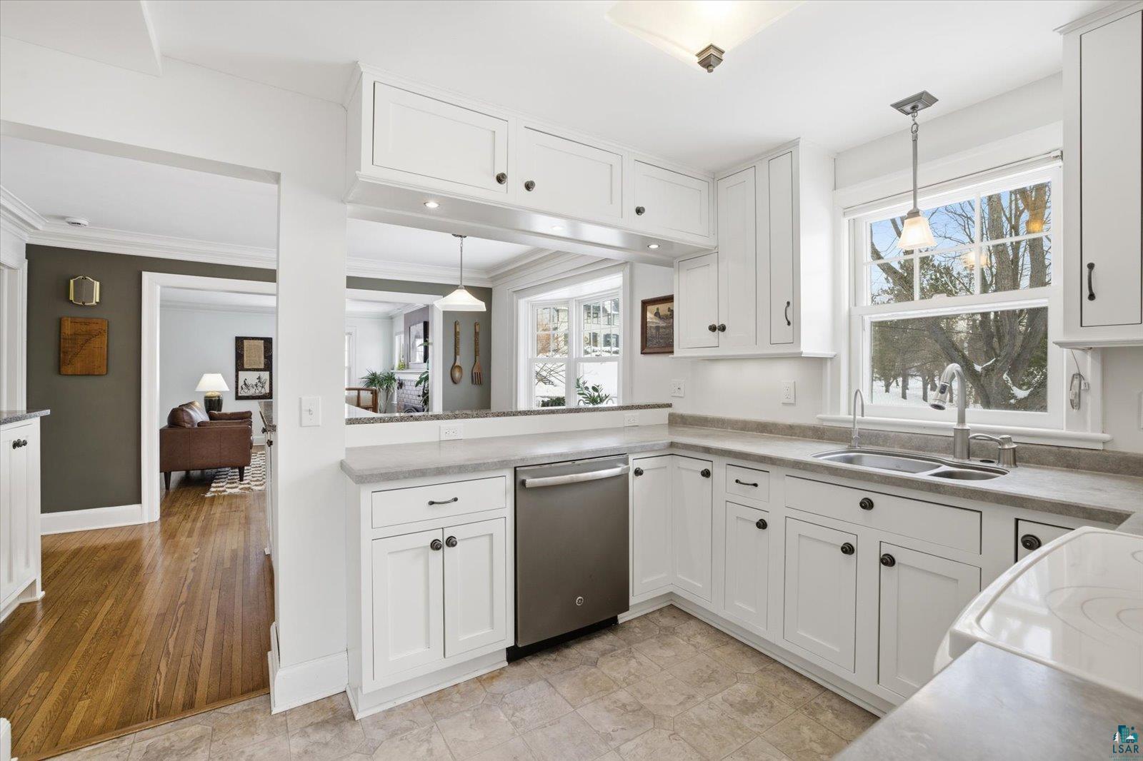 2201 Vermilion Road Duluth, MN 55803 - Photo 18 of 79 Kitchen with pendant lighting, white cabinetry, light countertops, and crown molding