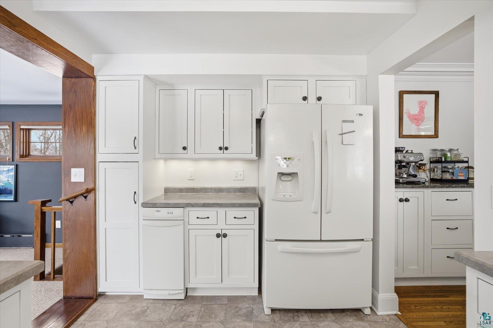 2201 Vermilion Road Duluth, MN 55803 - Photo 19 of 79 Kitchen with white fridge with ice dispenser, white cabinets, and light countertops