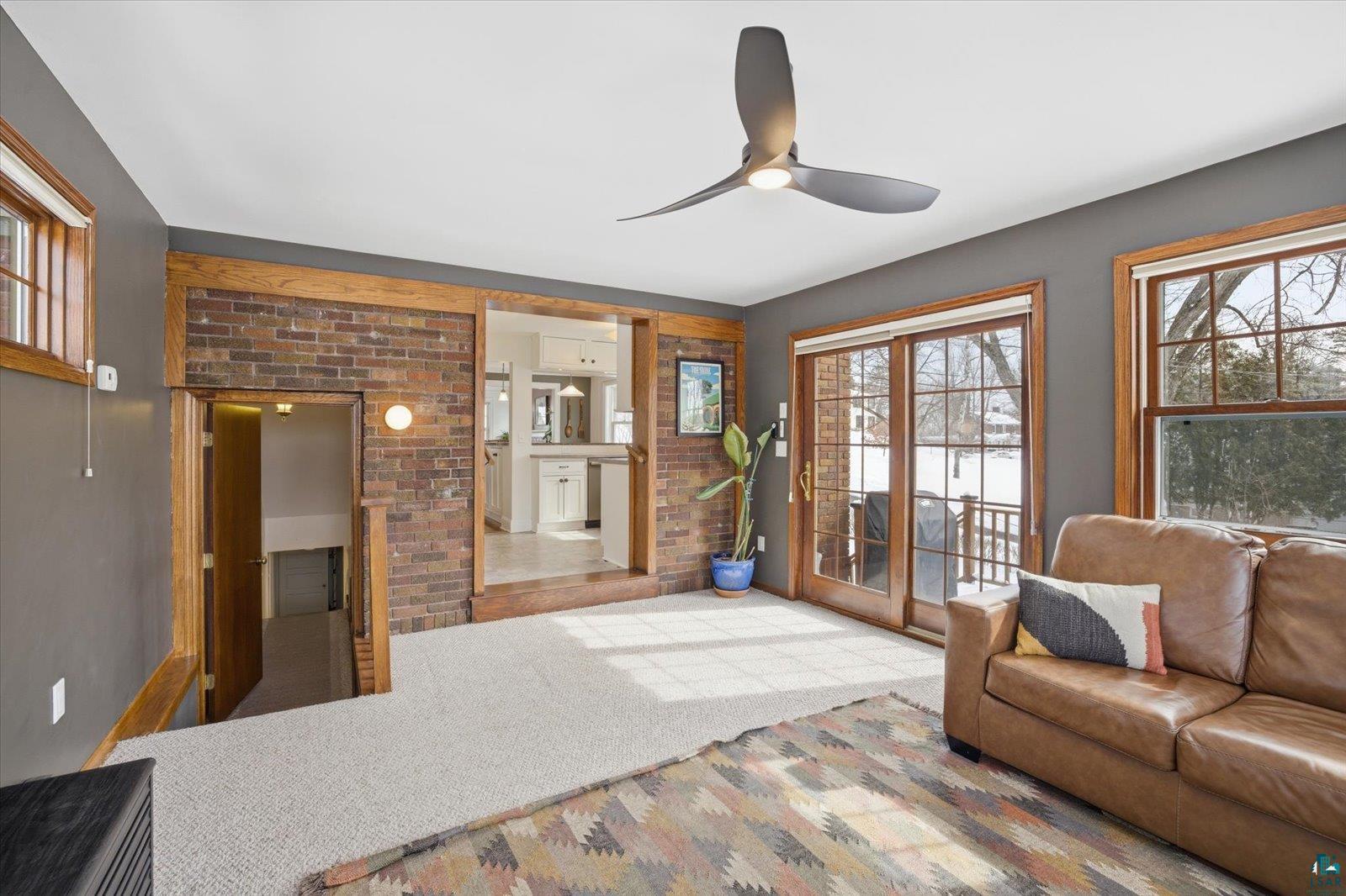 2201 Vermilion Road Duluth, MN 55803 - Photo 22 of 79 Living room featuring ceiling fan, carpet floors, and a fireplace