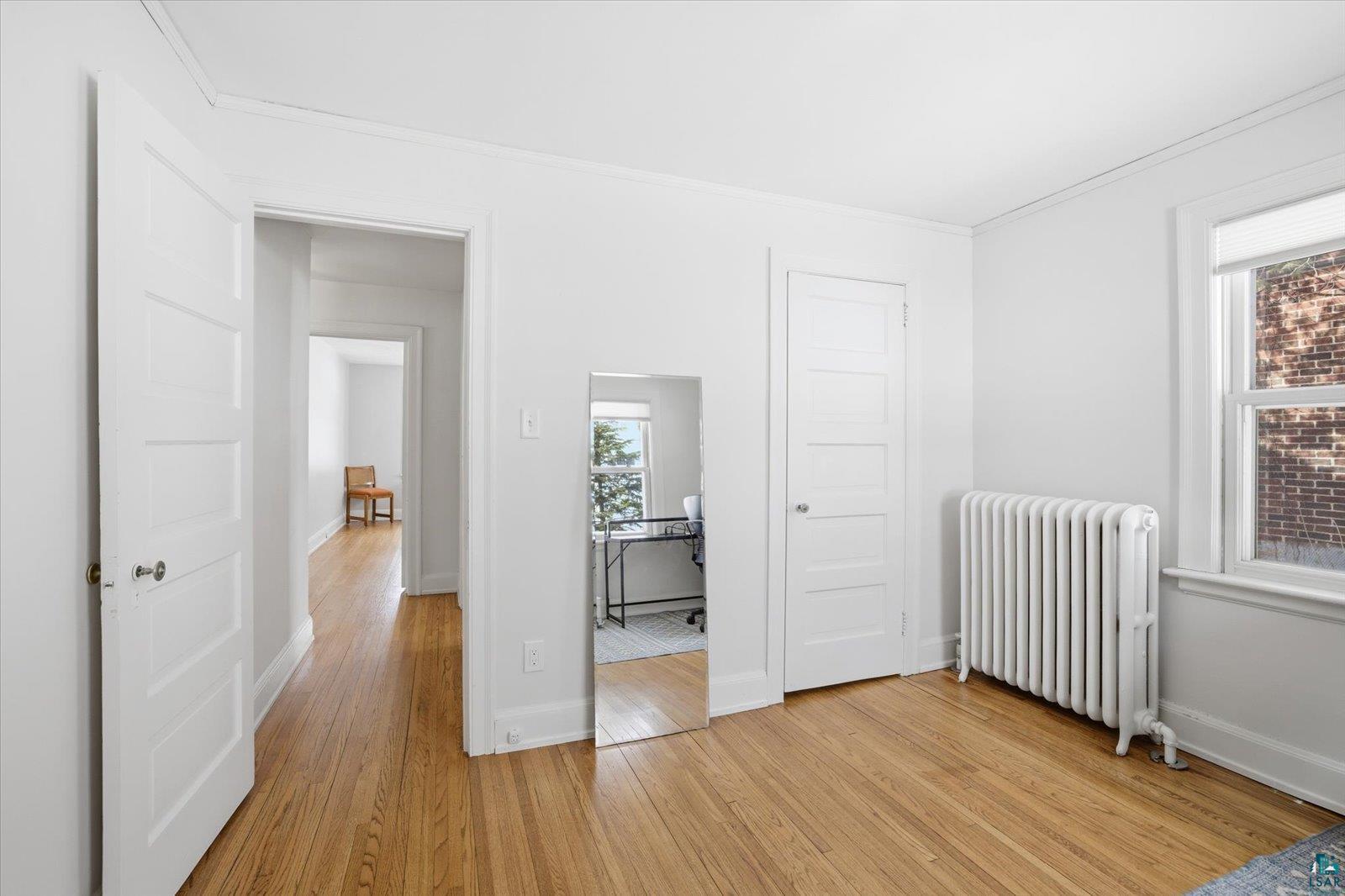 2201 Vermilion Road Duluth, MN 55803 - Photo 31 of 79 Bedroom with radiator, light wood-style floors, and ornamental molding