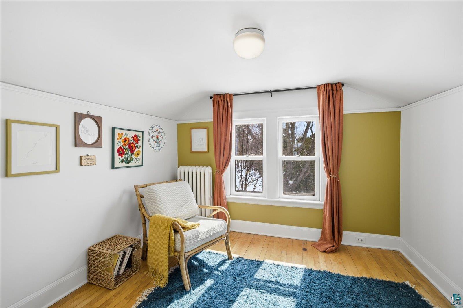 2201 Vermilion Road Duluth, MN 55803 - Photo 33 of 79 Sitting room featuring vaulted ceiling, light wood finished floors, and radiator heating unit