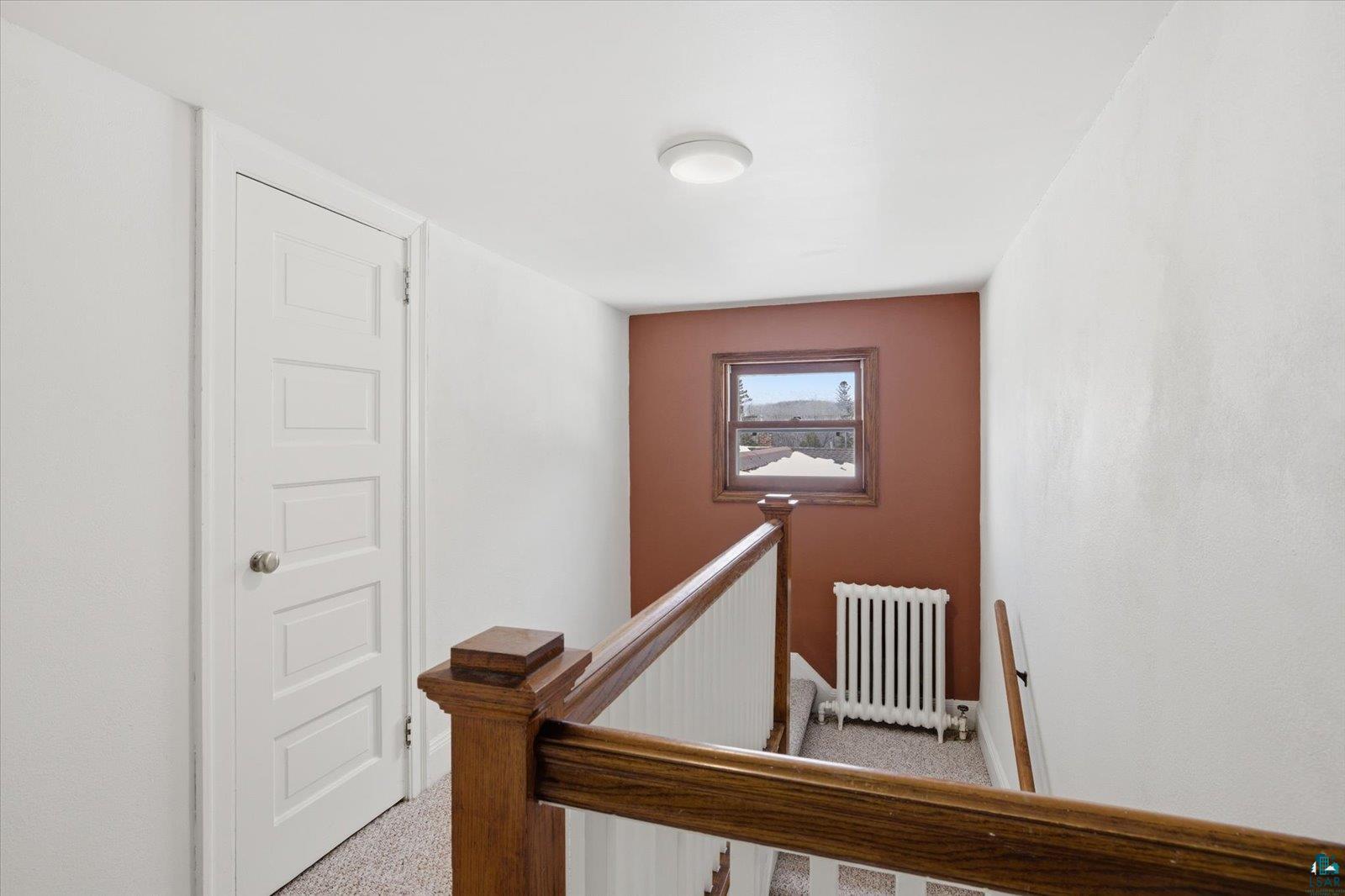 2201 Vermilion Road Duluth, MN 55803 - Photo 38 of 79 Staircase with radiator heating unit and carpet